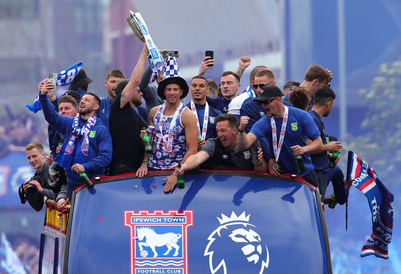 Town players celebrate promotion to the Premier League on a bus