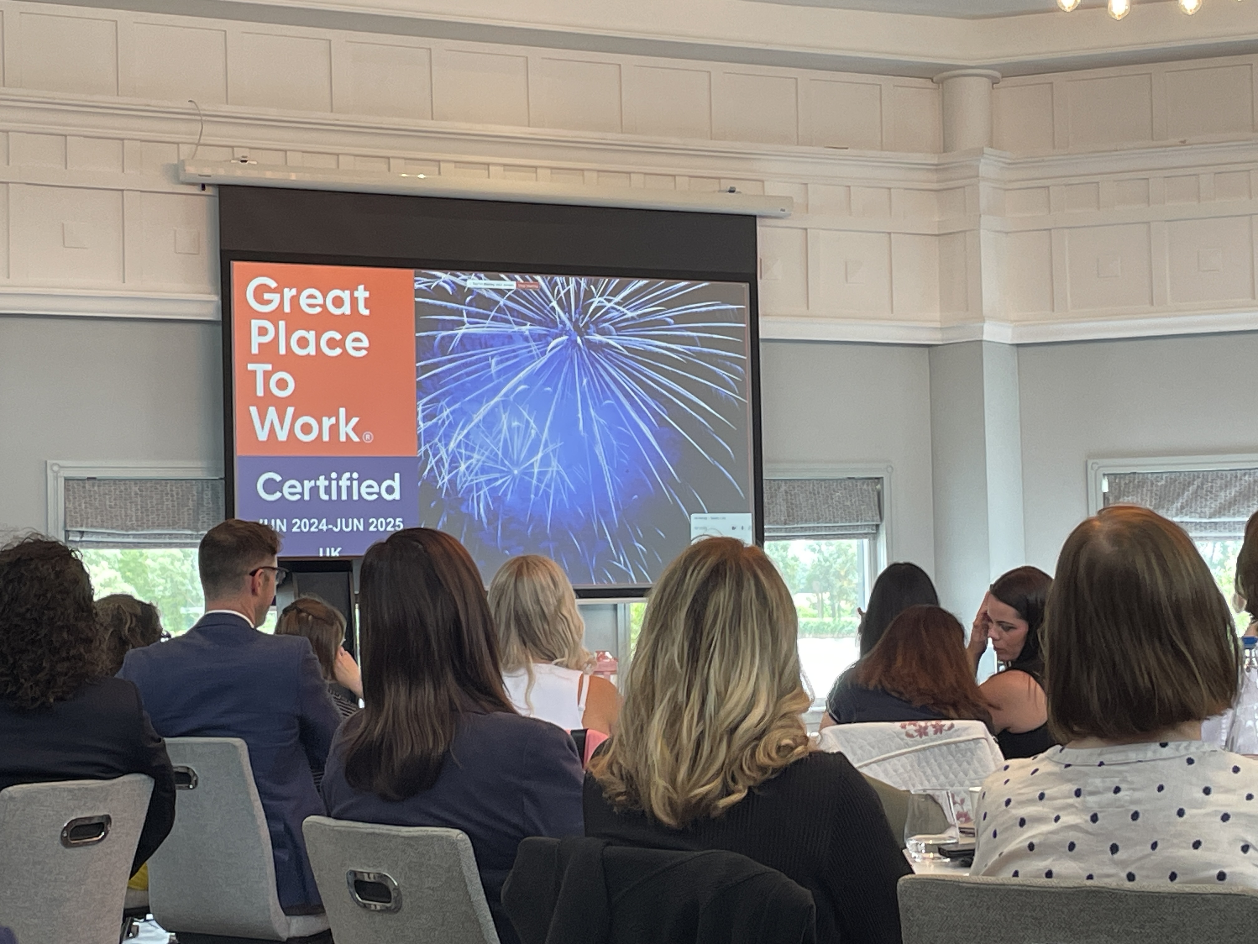 DPO Centre team viewing a presentation on being certified as a great place to work