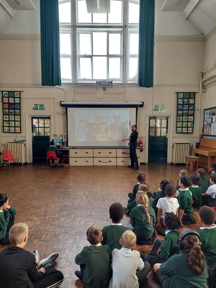 PC Sam speaking to pupils at a school