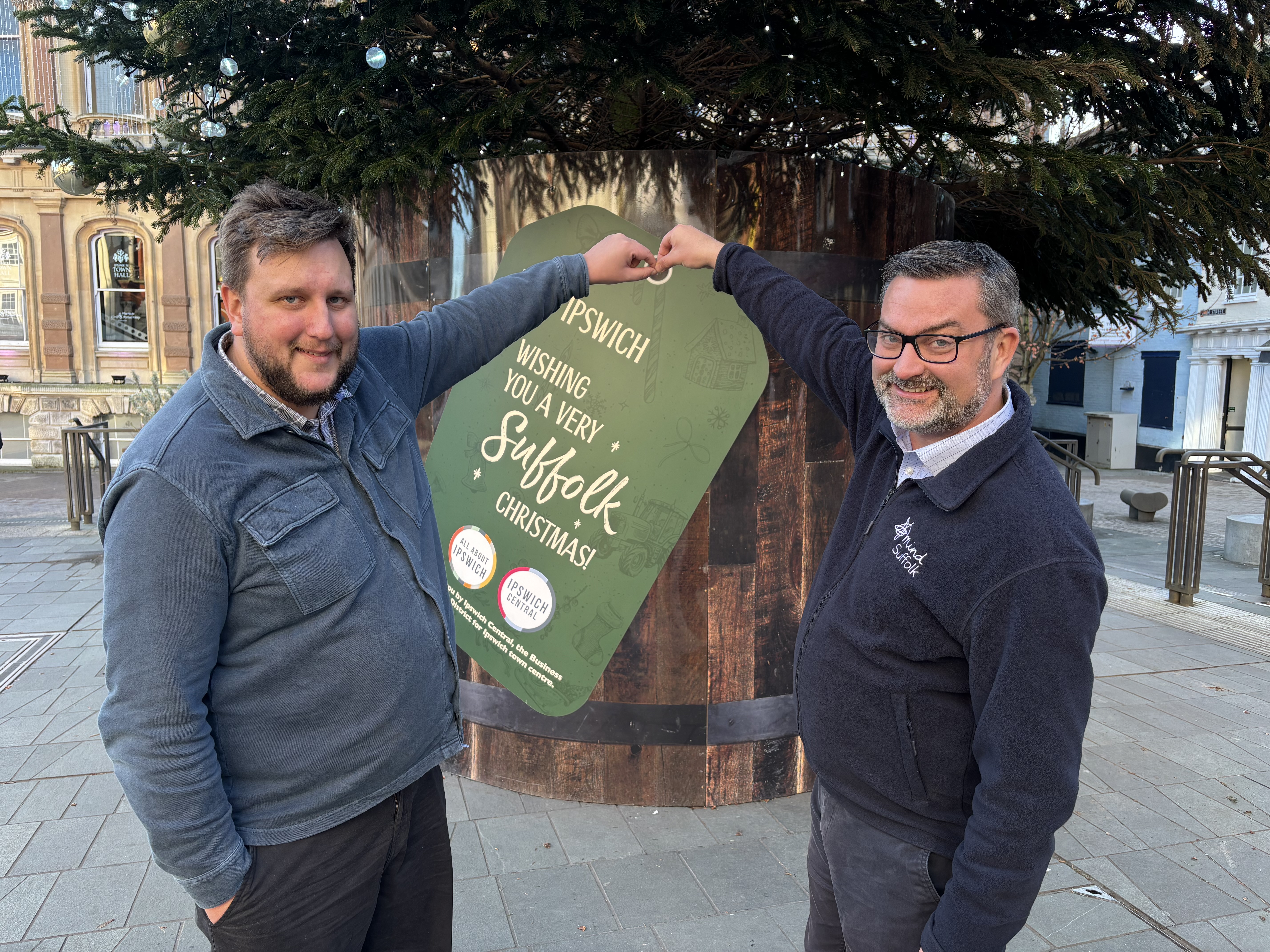 Lee Walker and Jon Neal in front of the Christmas tree on the Cornhill