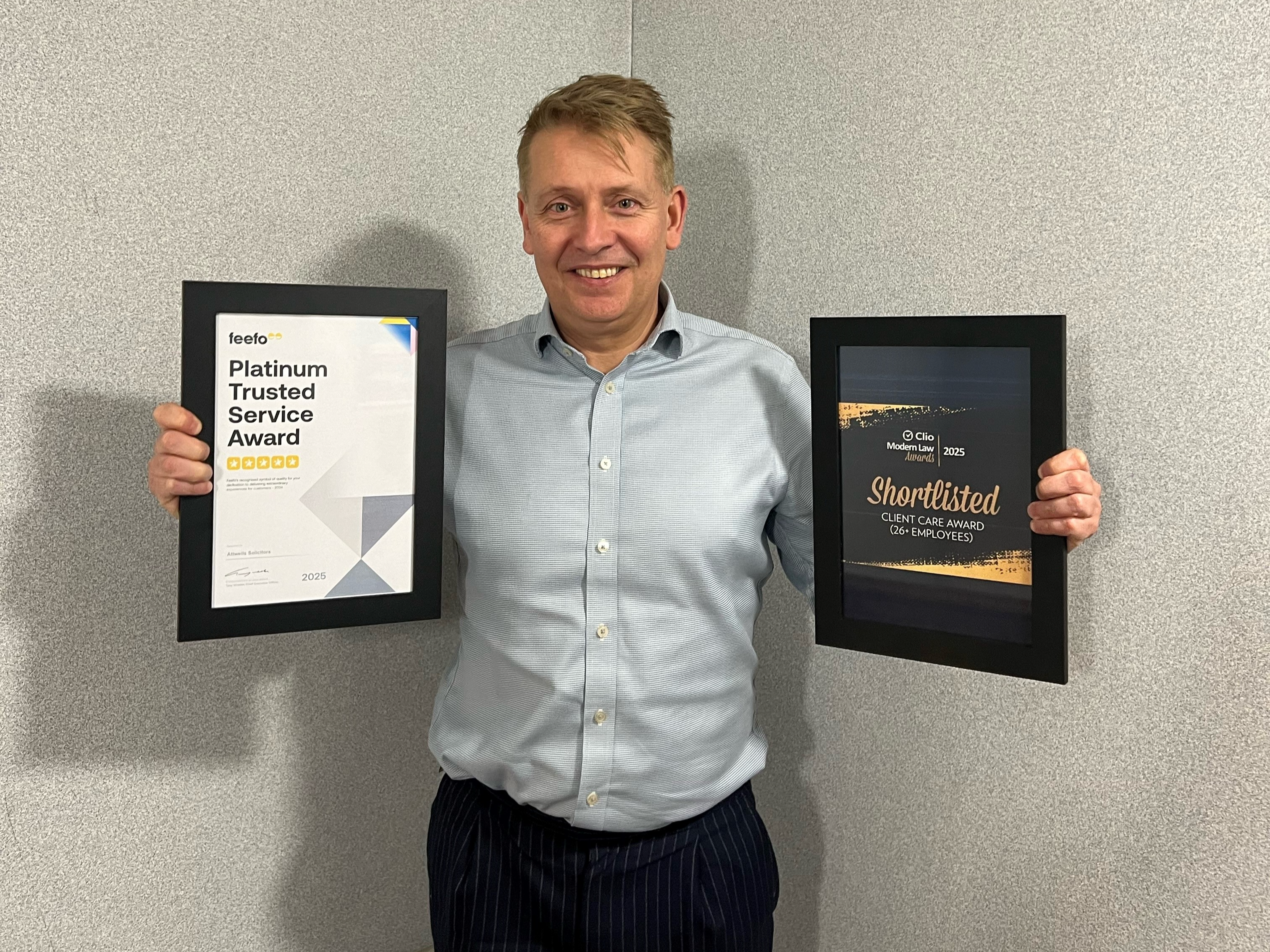 Nick Attwell from Attwells Solicitors holding two awards