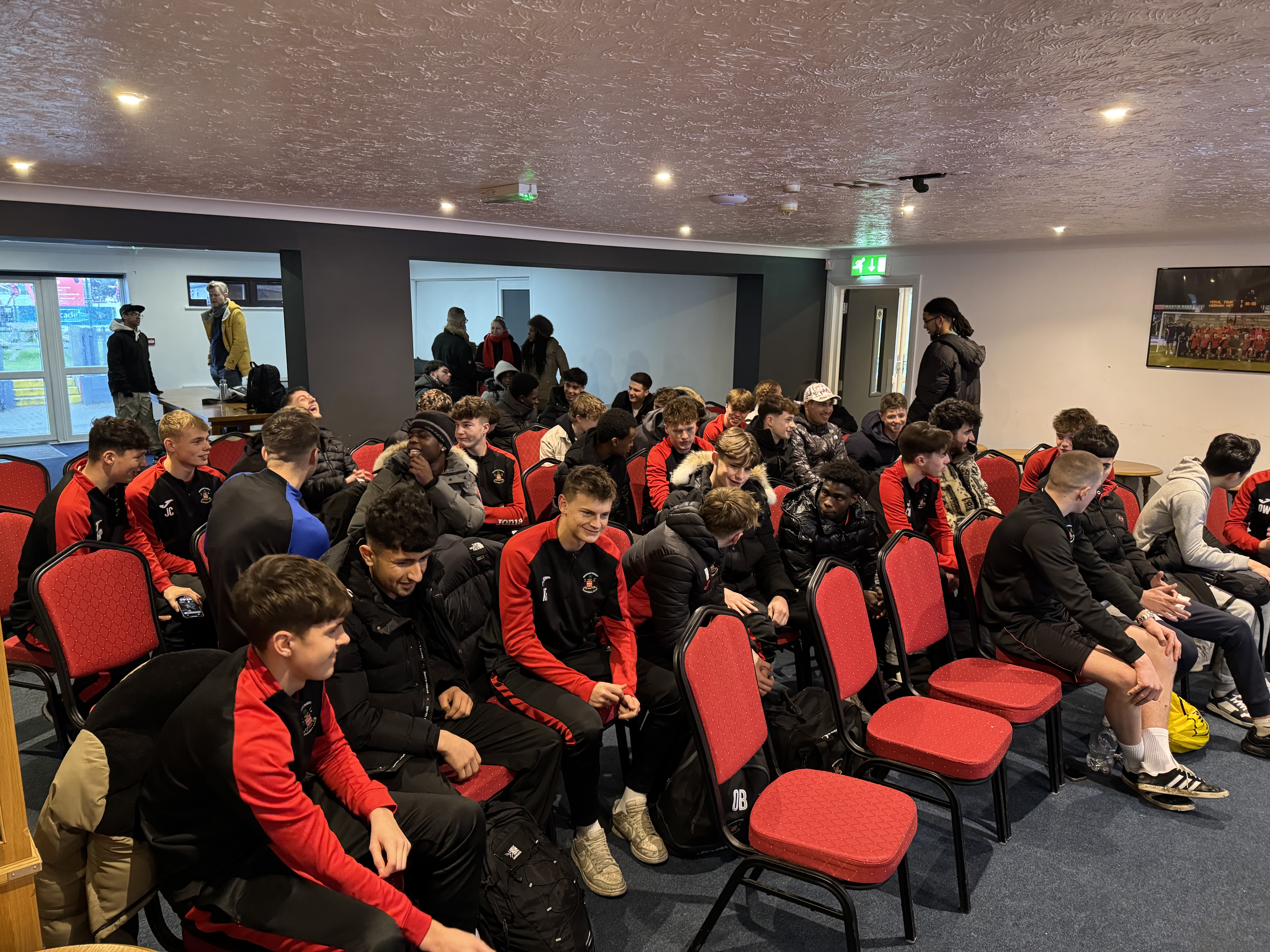 Needham Market Academy players and young South Sudanese and Iraqi men getting to know eachother