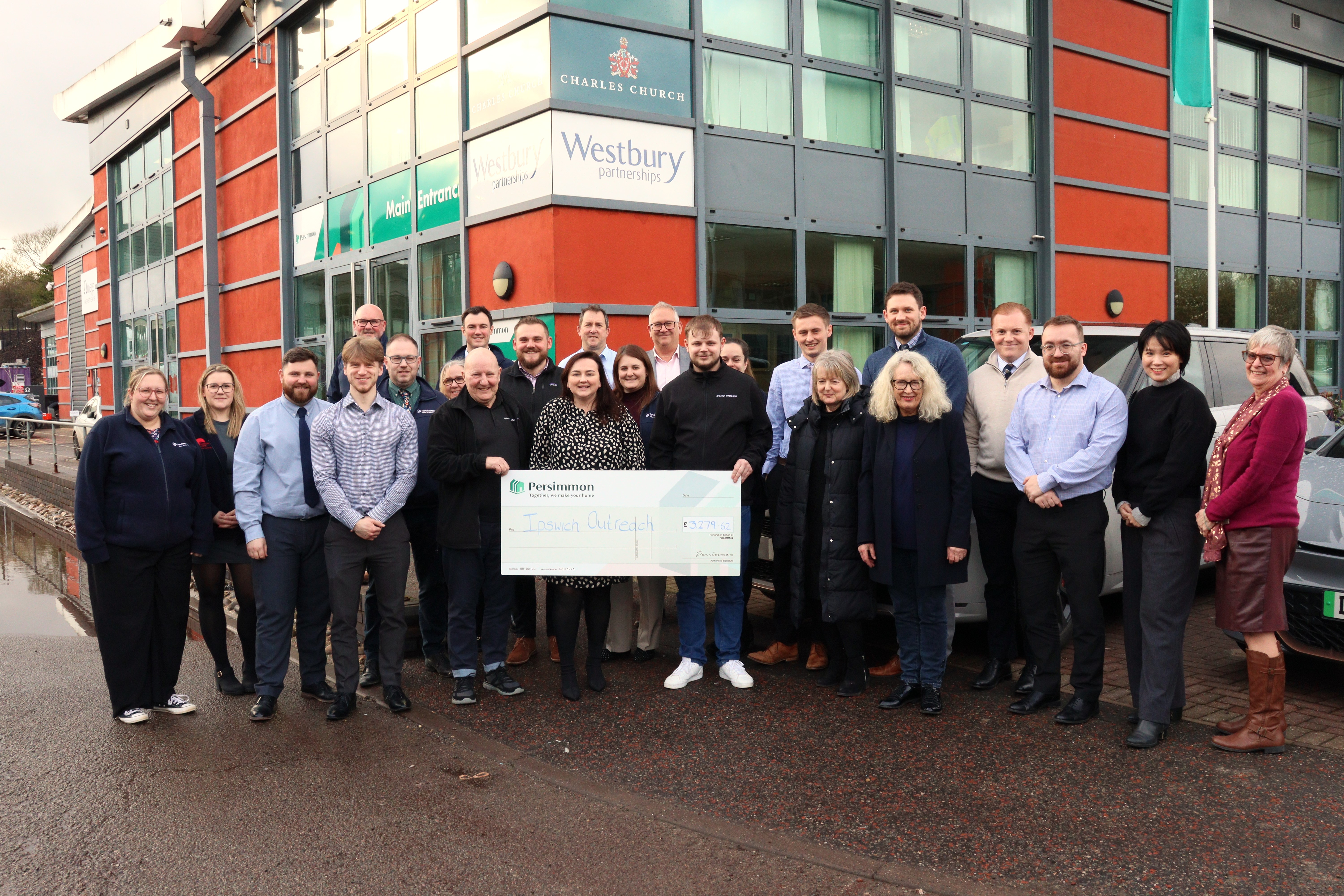 Persimmon Homes team presenting the Ipswich Outreach team with a giant cheque