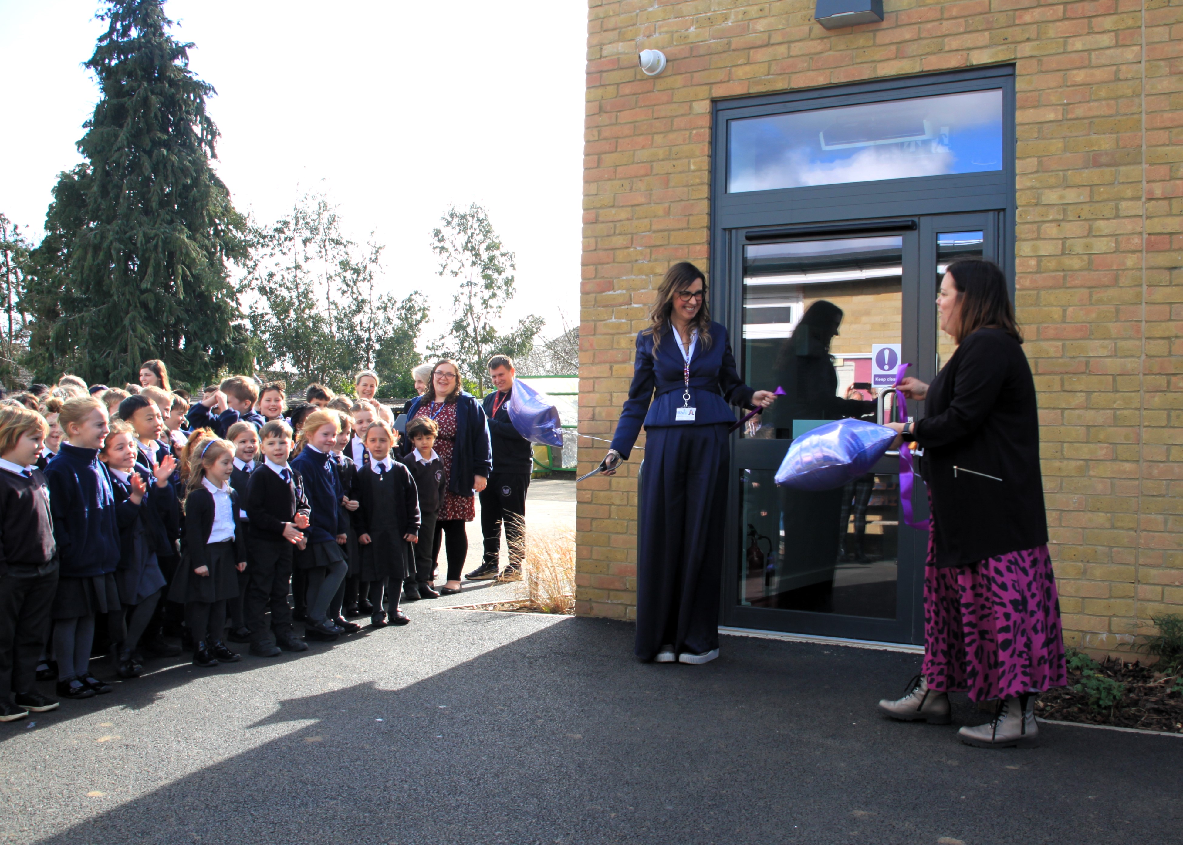 Cathie Paine and Emma Churchman cutting the ribbon at the opening of Martlesham Primary