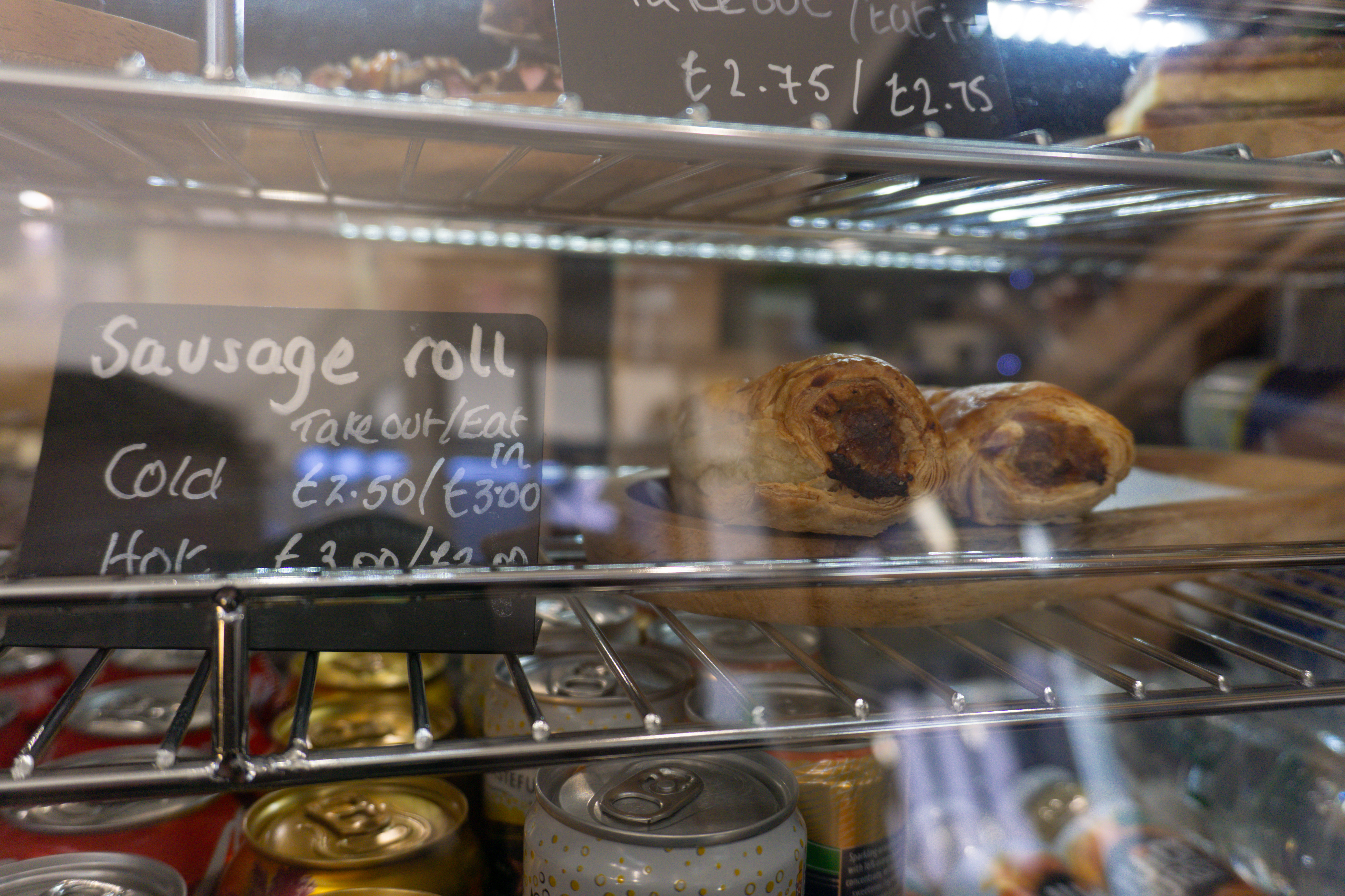A fridge with food and soft drinks inside