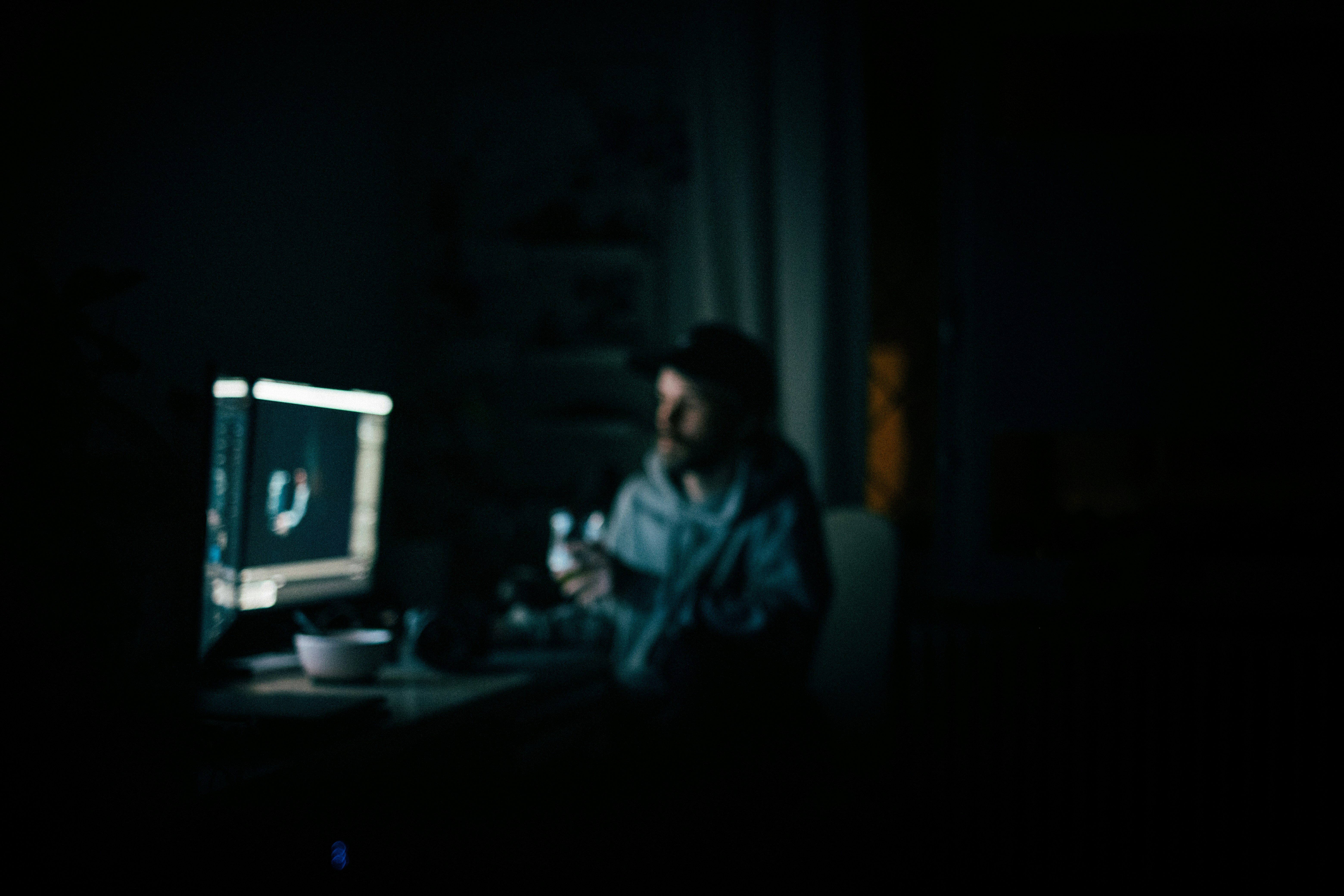 A man working at his computer late at night