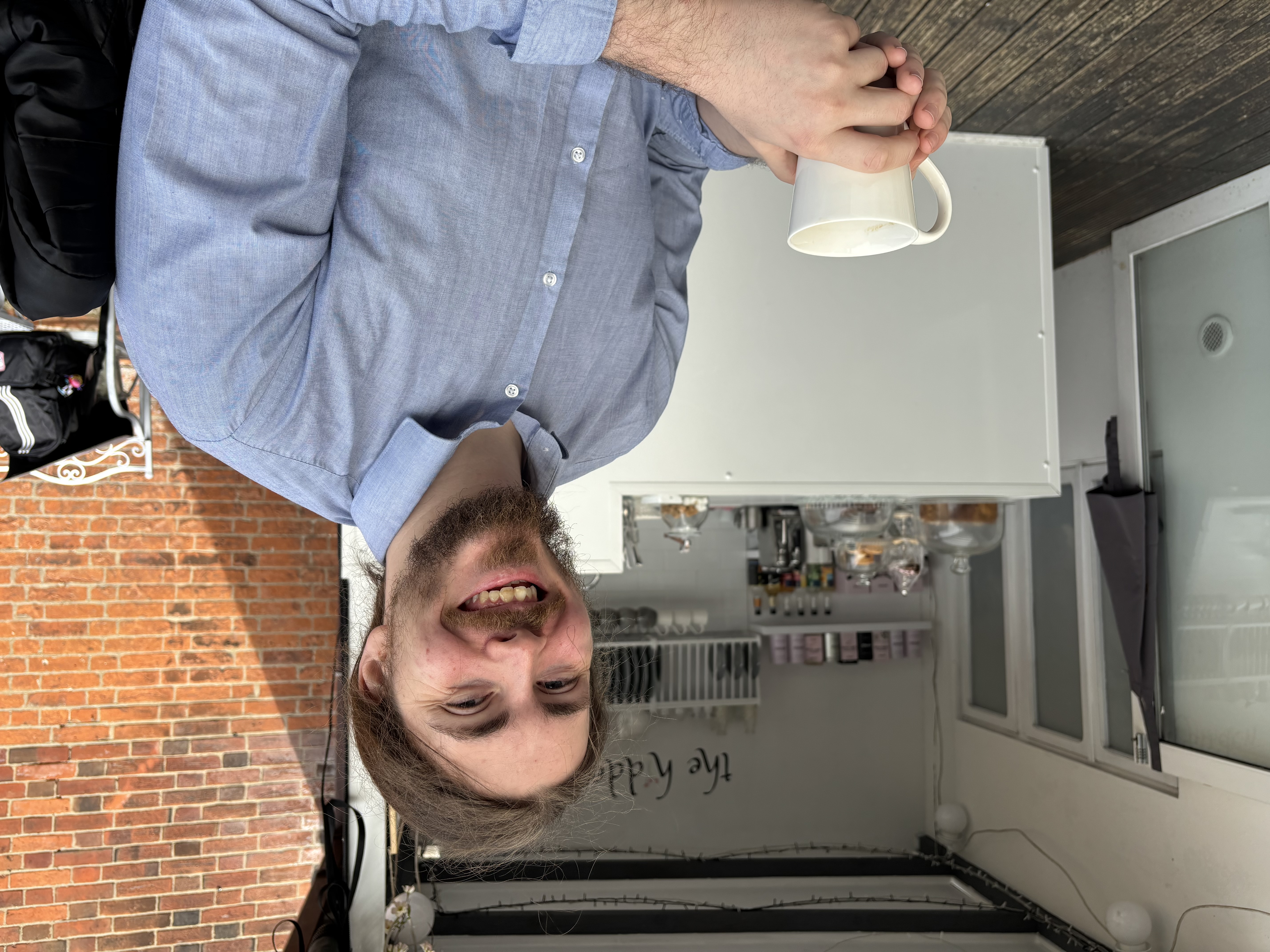 Adam Littler sitting in a cafe