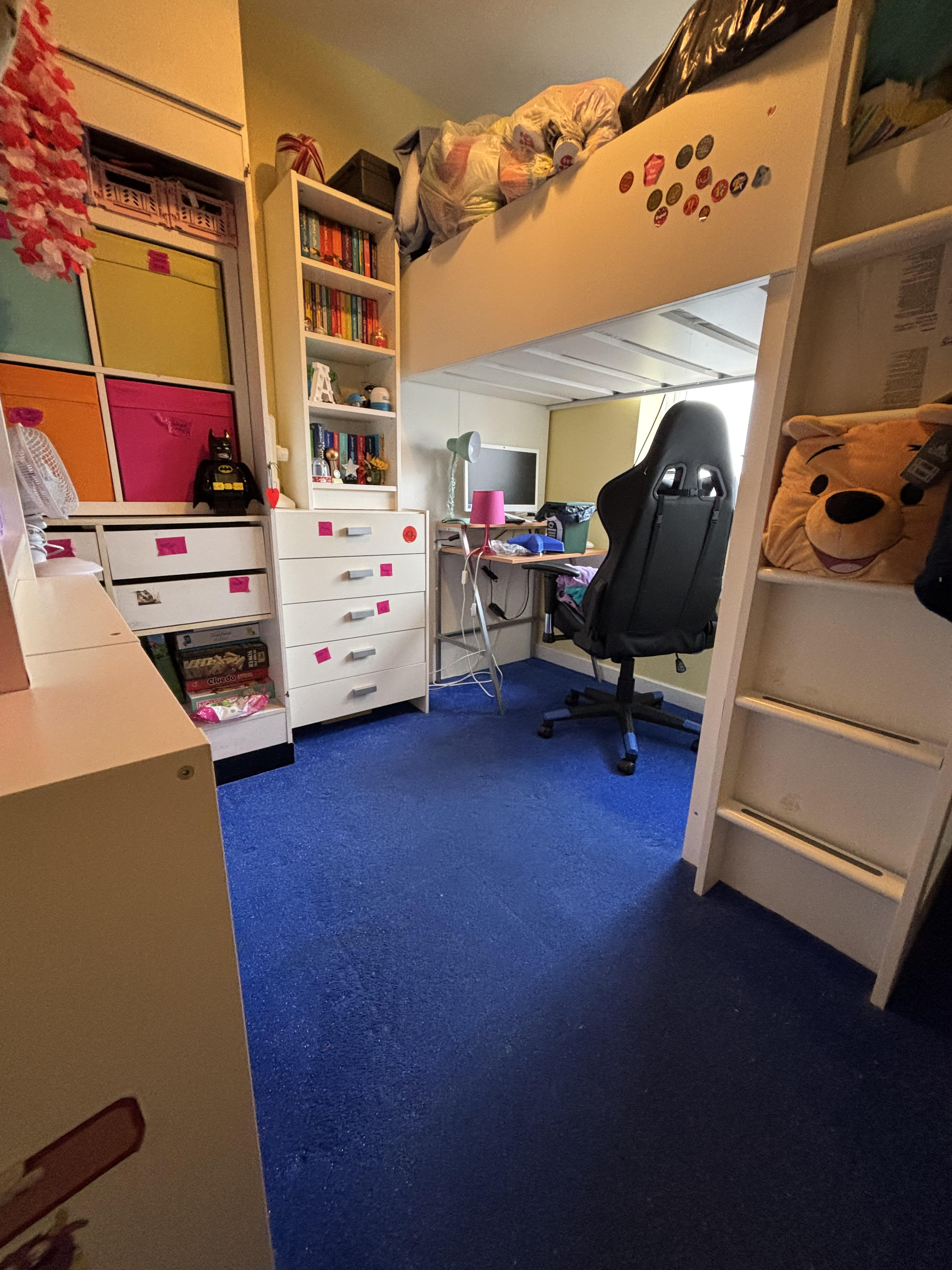 Organised child's bedroom with bunk bed, clear floor space, tidy shelving and proper storage systems