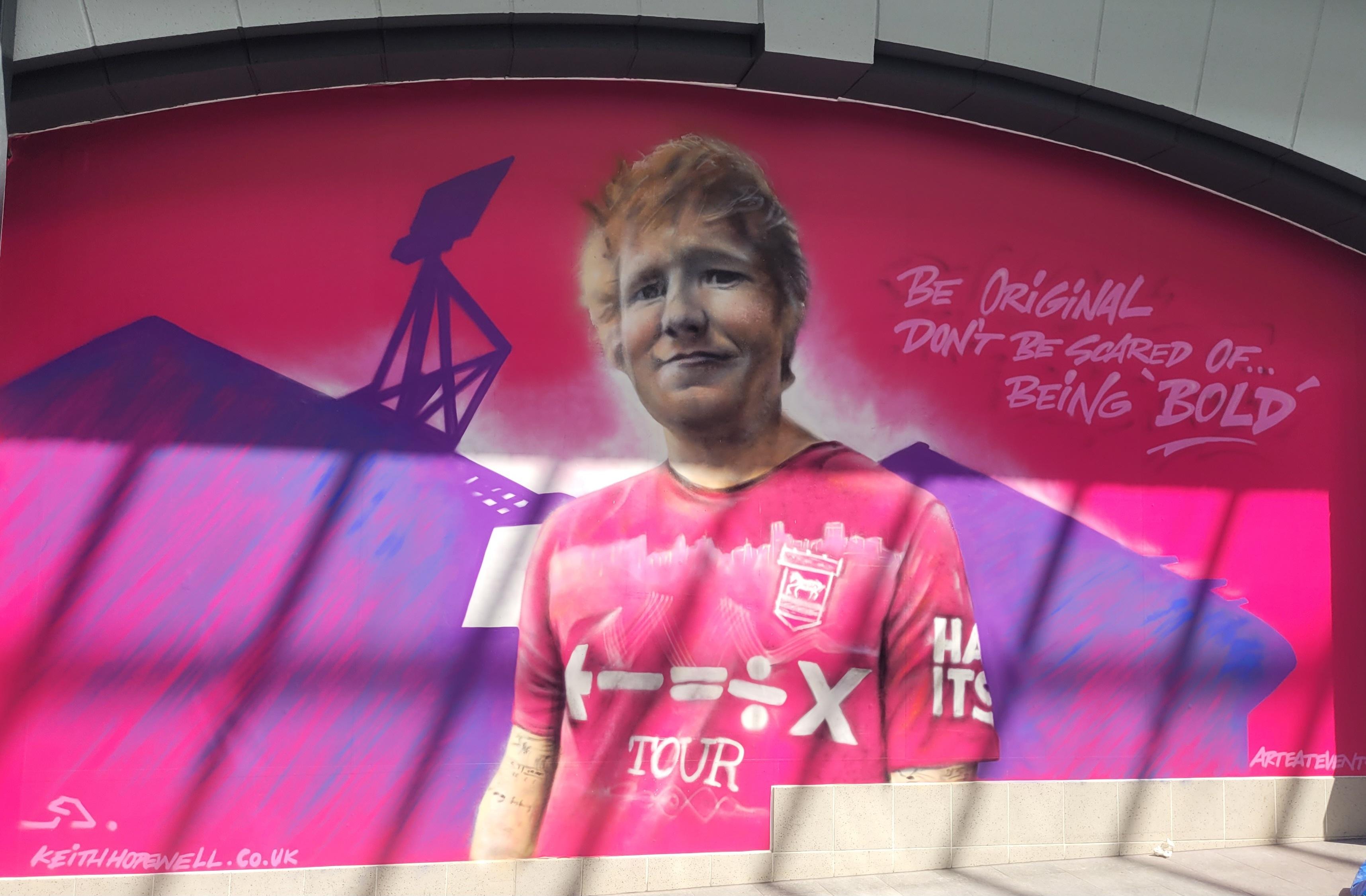The Ed Sheeran mural by Keith Hopewell is part of the town-wide "Paint the Town Pink" campaign
