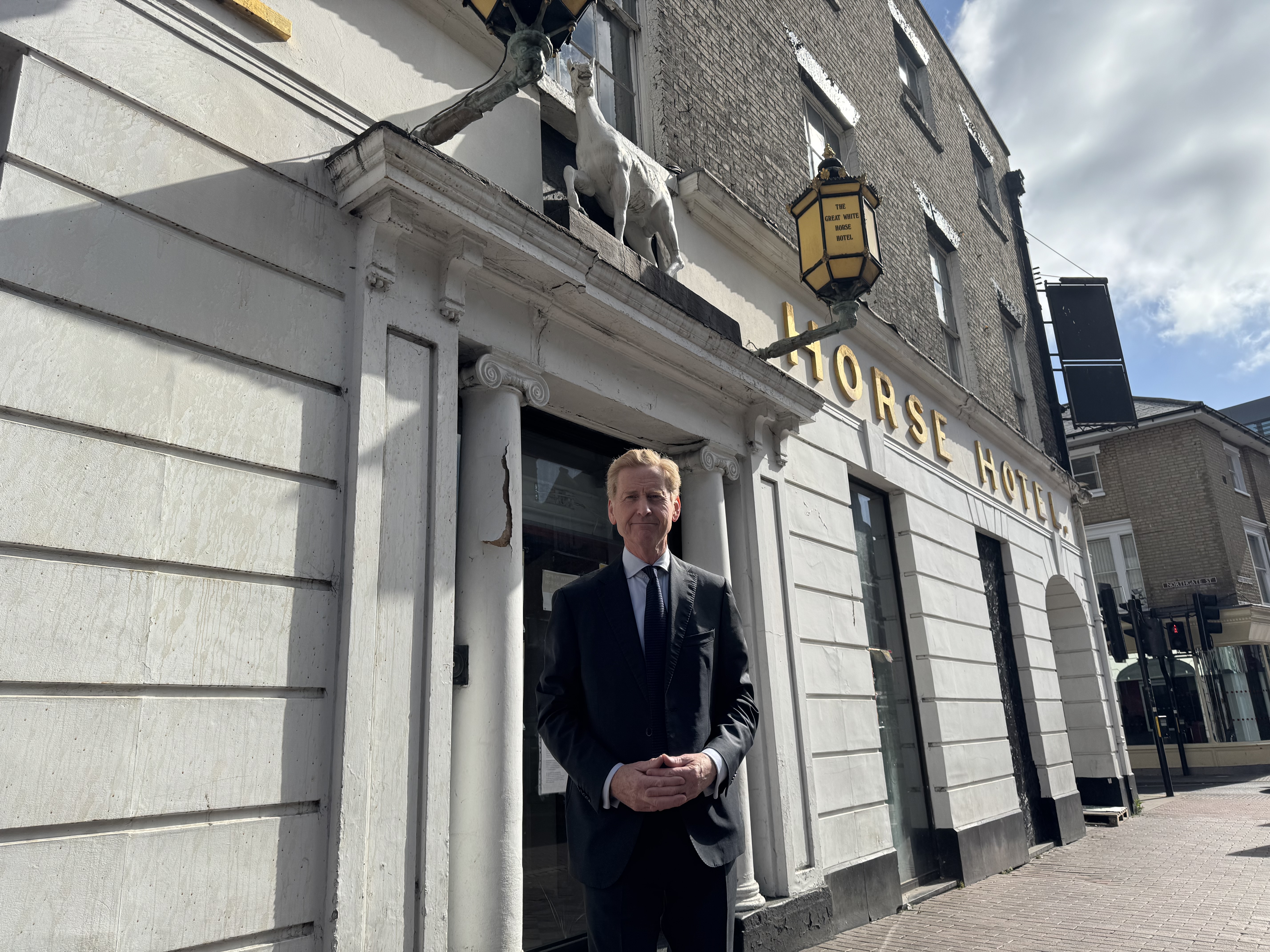 John Howard in front of the Great White Horse hotel shortly after he acquired it