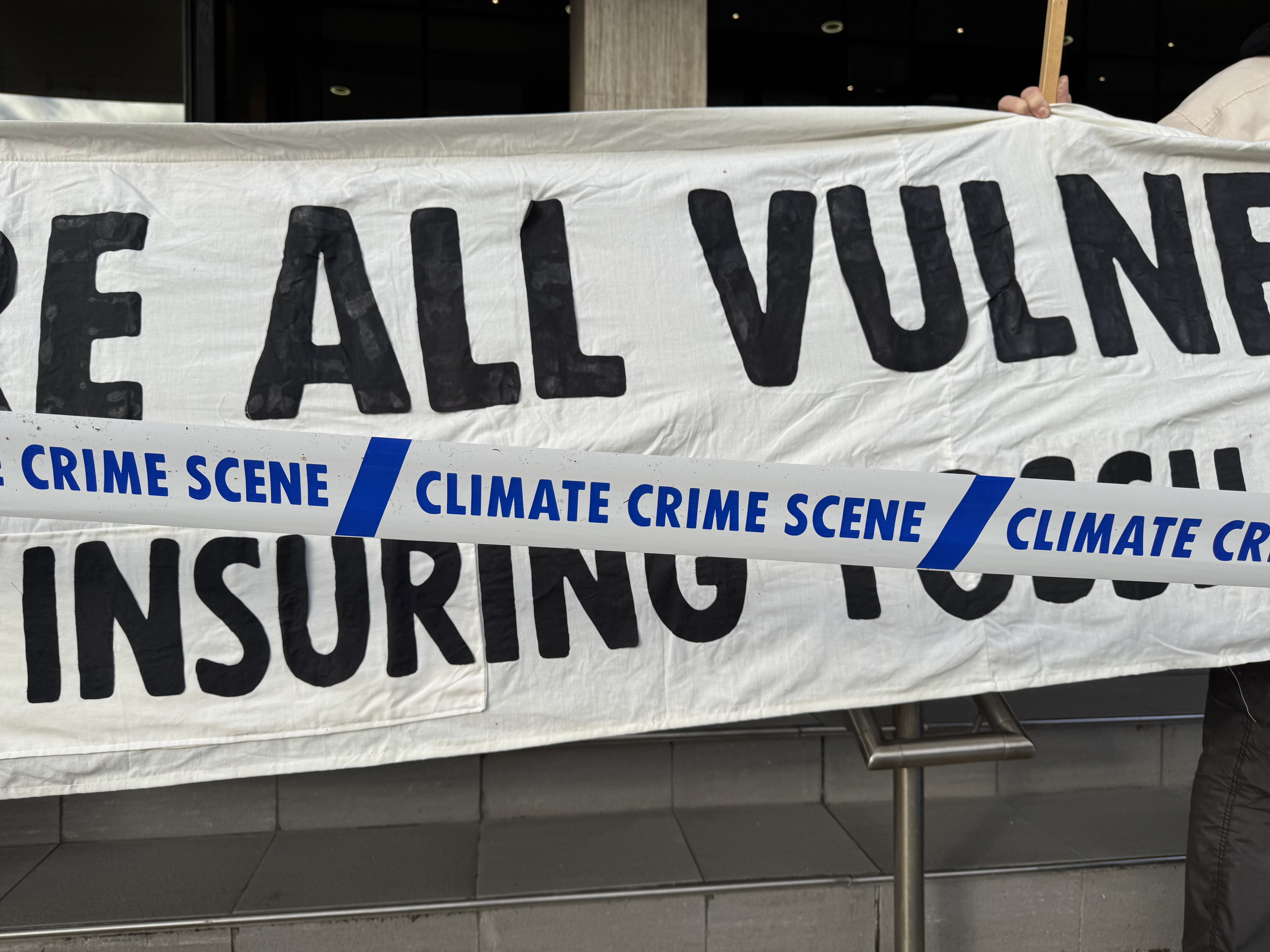 Extinction Rebellion activists displayed a "Climate Crime Scene" tape at the entrance of AXA's Civic Drive office