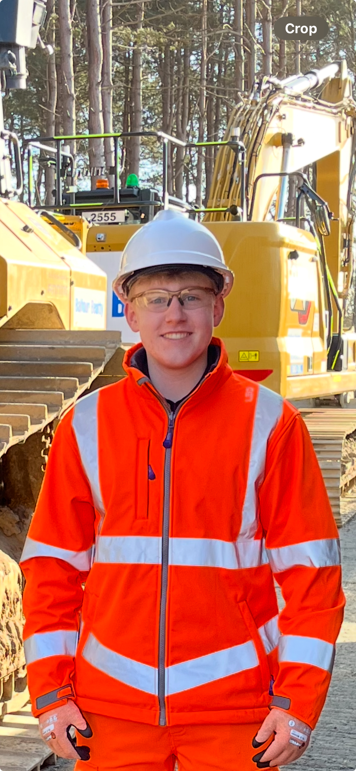 Young apprentice in construction site uniform