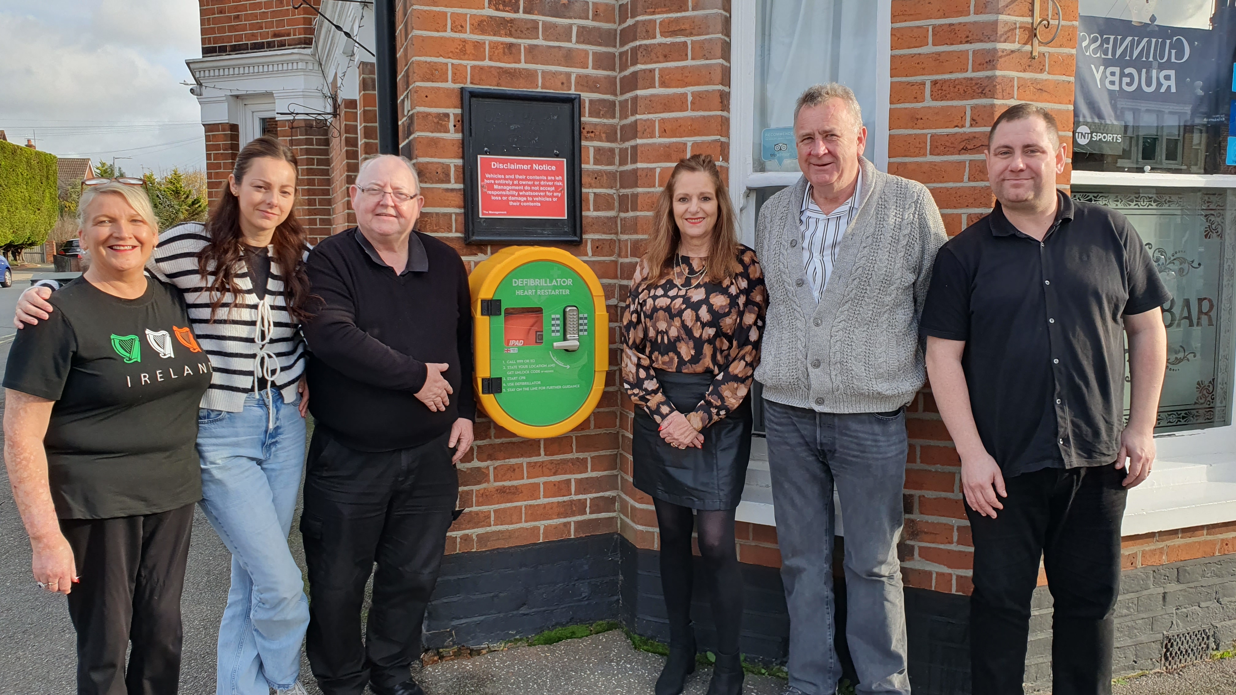People stood in a line outside building