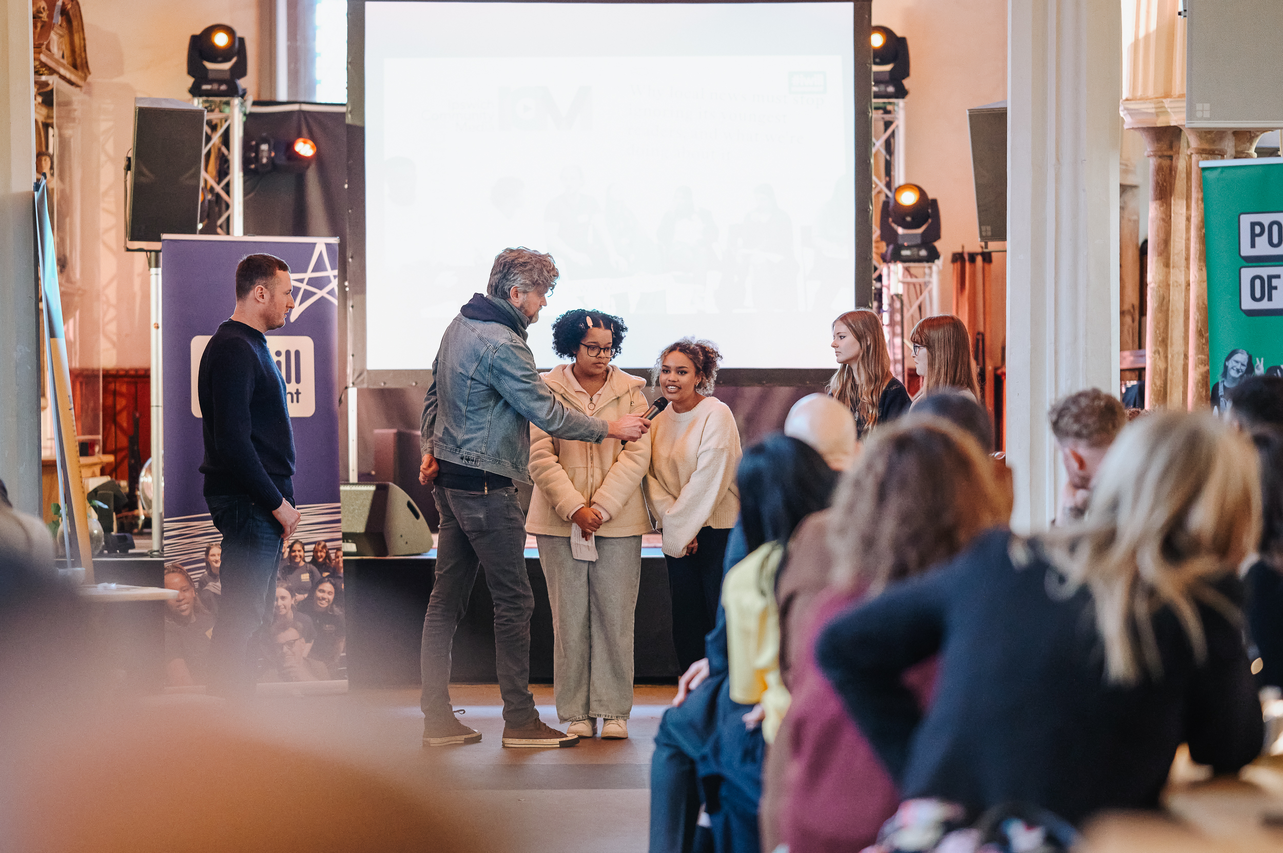 Ipswich.co.uk founder Oliver Rouane-Williams and Ben Miller from ICM on stage with student journalists Shamena, Tiah, Ruby and Holly