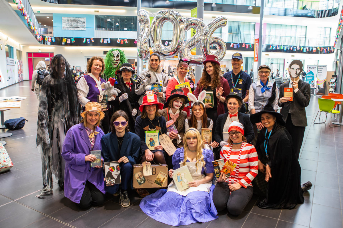 Staff and students in the atrium at Suffolk New College in fancy dress
