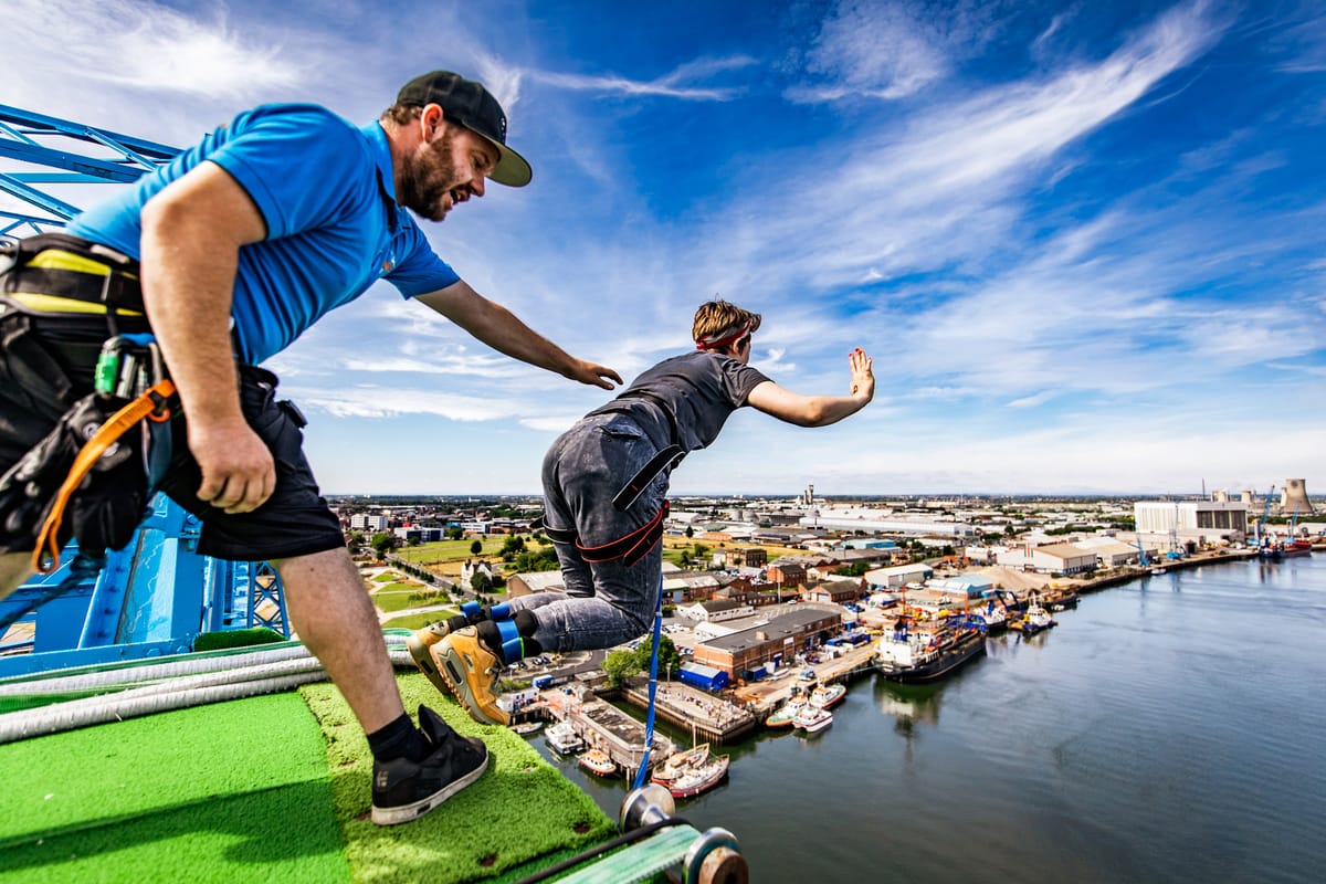 A man bungee jumping off a building