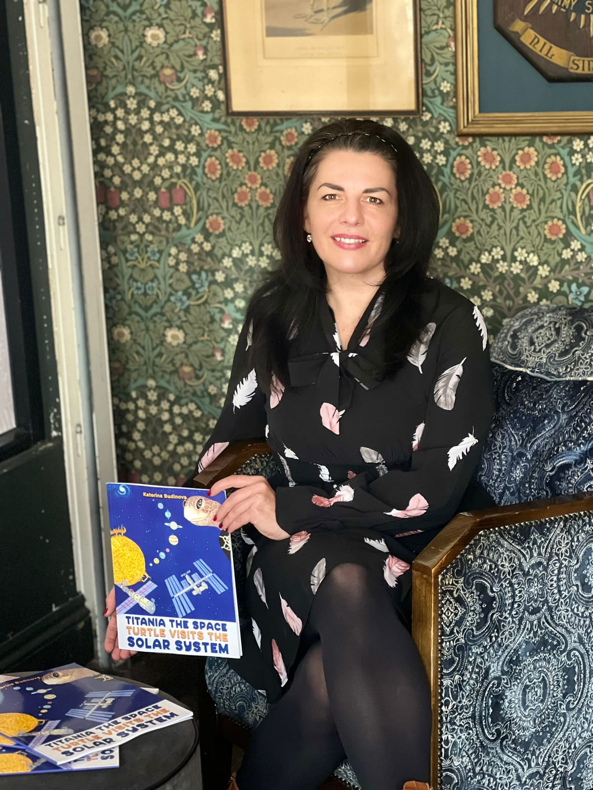 Katerina Budinova holding a copy of her book