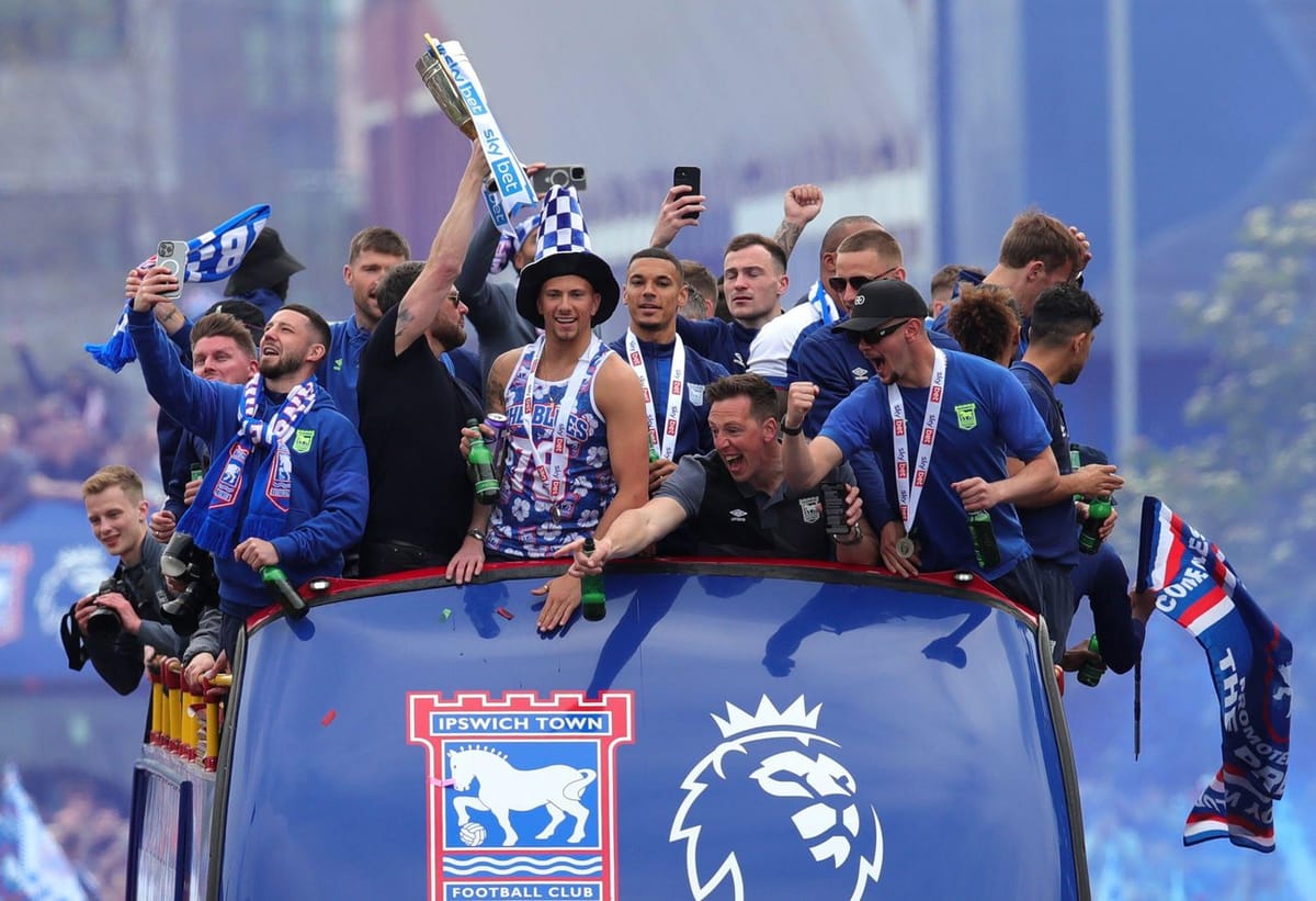 Town players celebrate promotion to the Premier League on a bus
