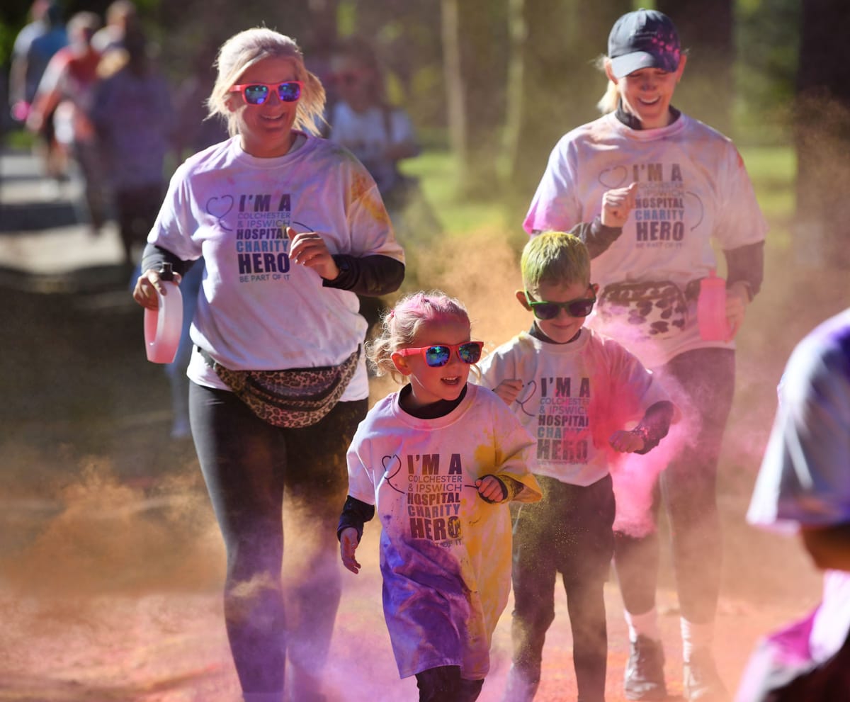 Two adults and two children take part in the colour run
