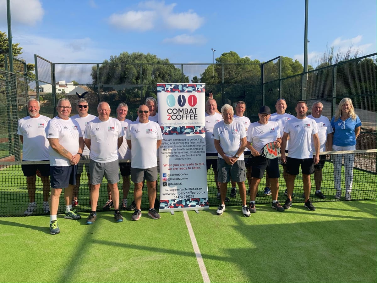 Menorca padelathon group in front of a Combat2Coffee sign
