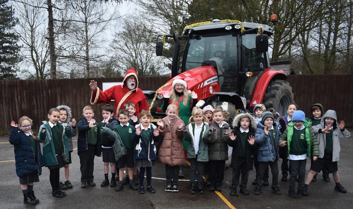 Children from the primary school at Witnesham get into the festive spirit with Farmer Christmas and his naughty elf helper