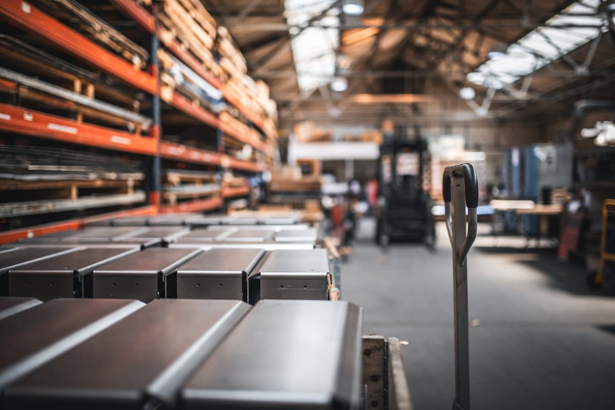 Finished product on a palets and raw material on shelves in a factory