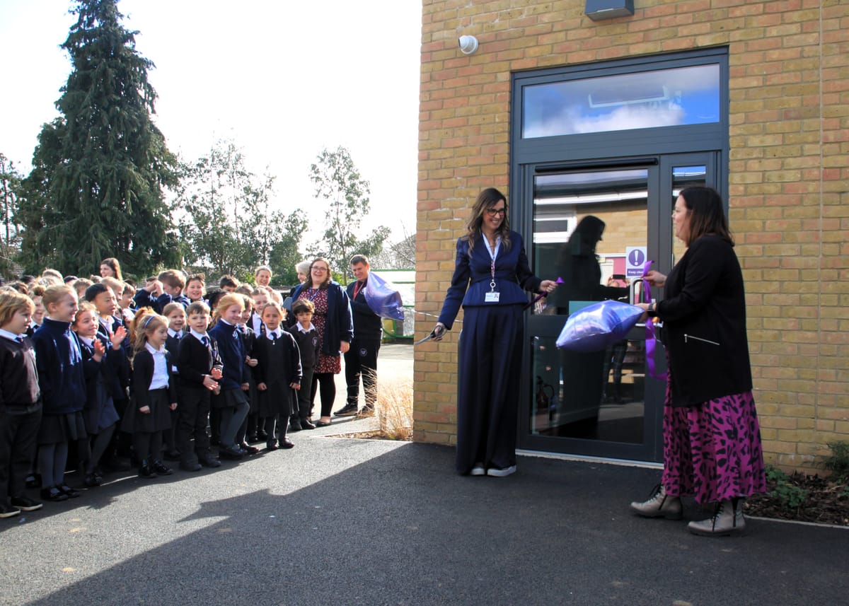 Cathie Paine and Emma Churchman cutting the ribbon at the opening of Martlesham Primary