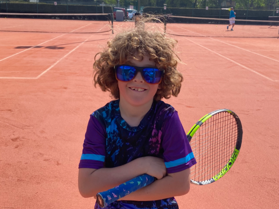 Charlie holding his tennis racket at Ipswich Sports Club