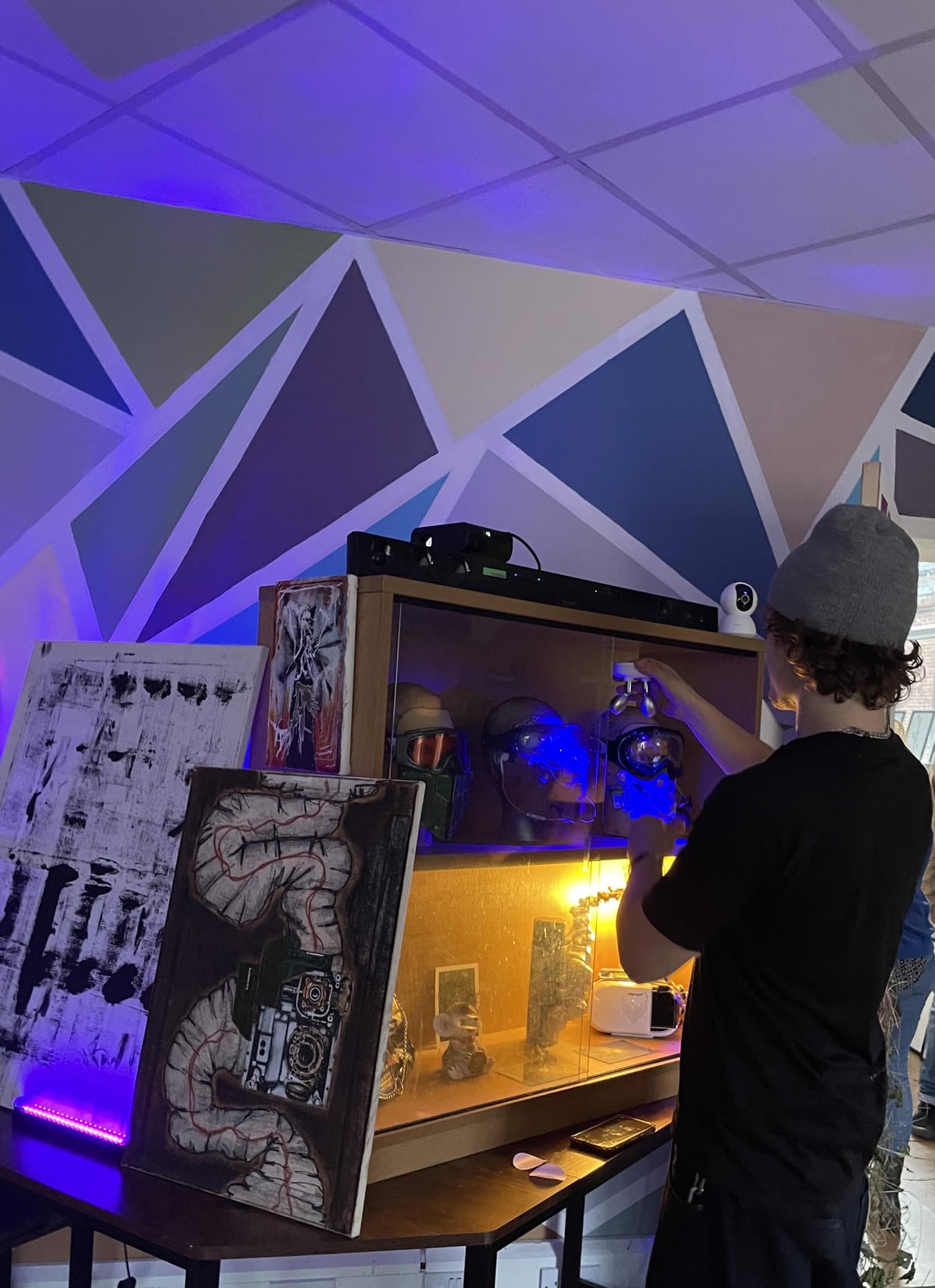 Cognito founder Leo adjusts an exhibition stand at CHIp Studios
