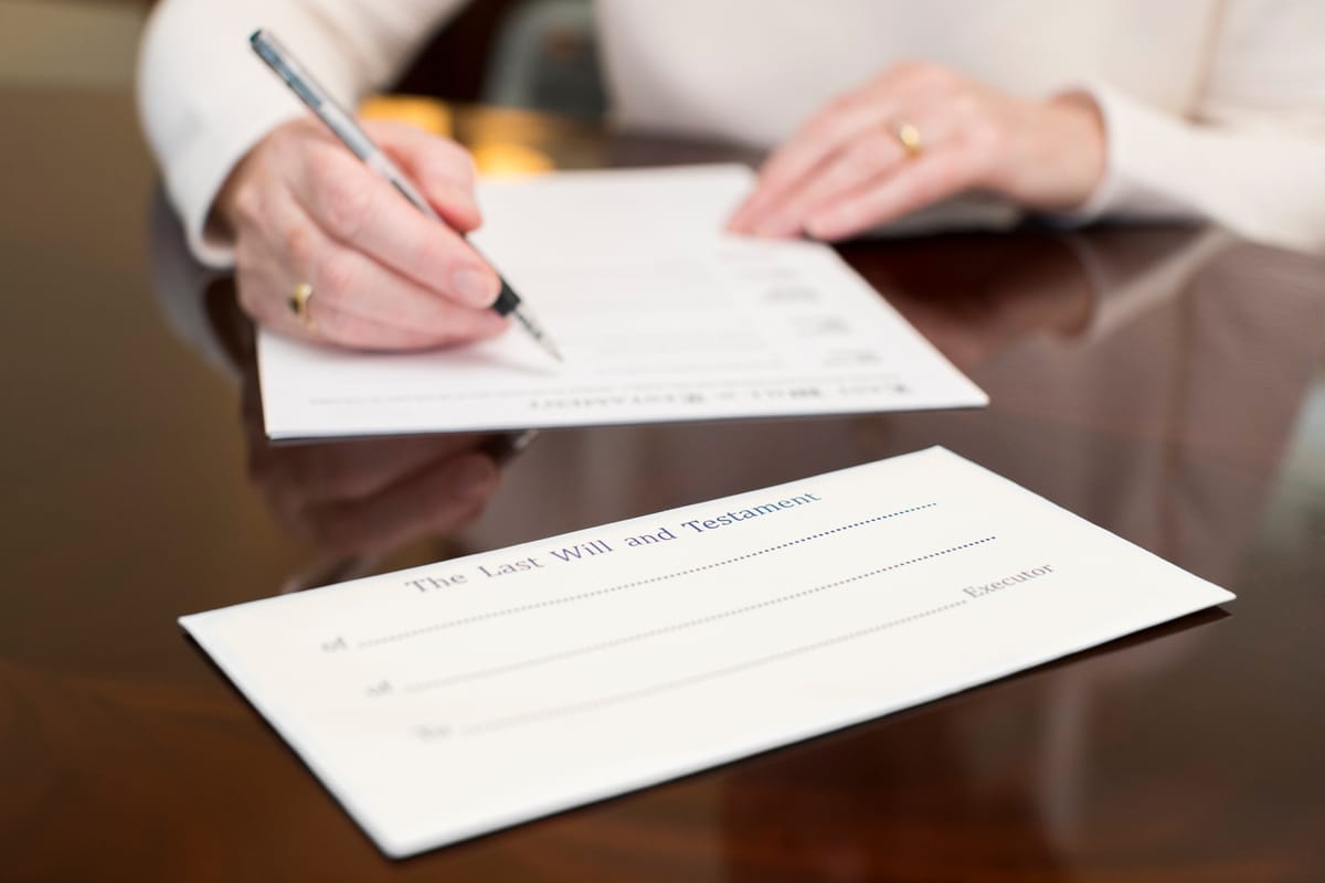 A woman signing a will