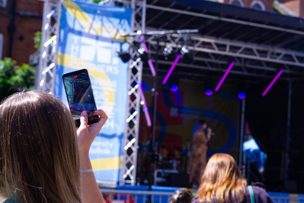People filming the brighten the corners festival
