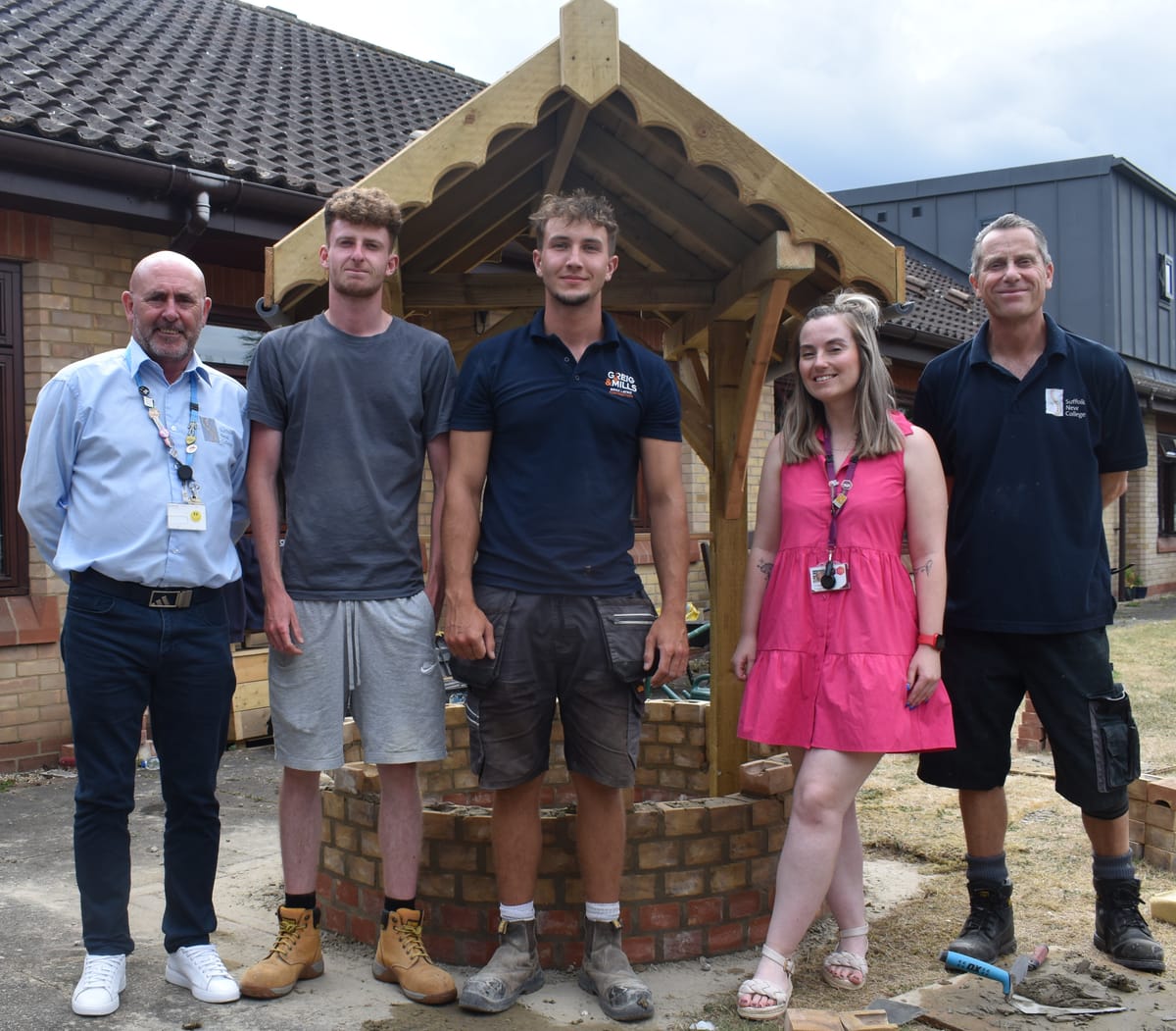 Mark Crisp, Nathan Berry, Ned Coles, Chloe Lock and Martin Cribb by the wishing well at St Elizabeth Hospice