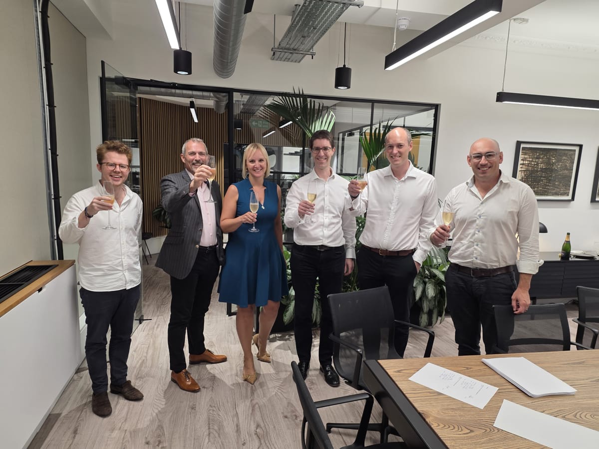 Group of people celebrating in office room