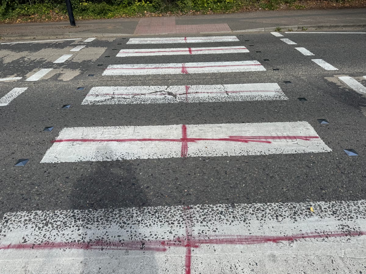 A pedestrian crossing on Shepherd's Drive in Pinewood painted with St George's Crosses