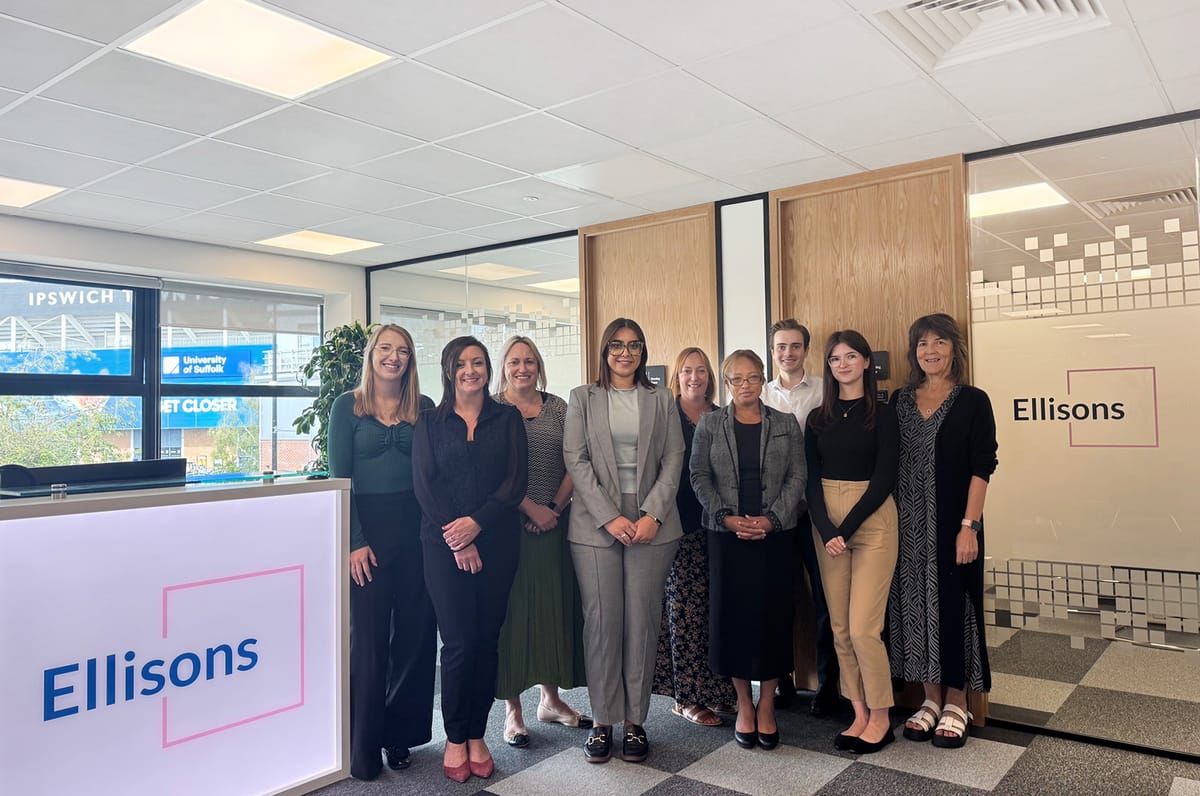 Group of people stood in office room