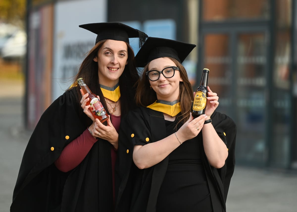 Adele Harris and Rebecca Mines holding their drinks