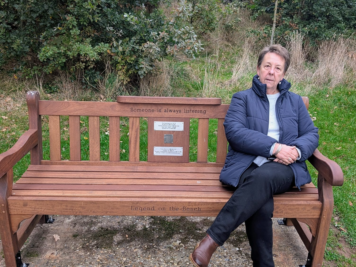 Cllr Trenchard sitting on the Bourne Park memory bench