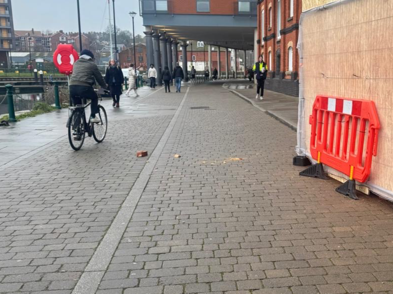 A brick fell from height and narrowly missed a pedestrian on Regatta Quay