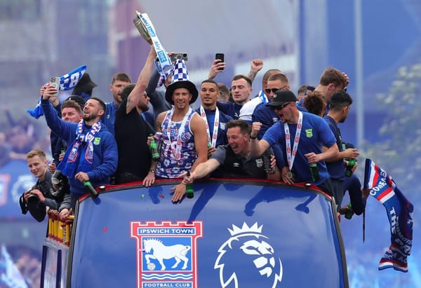 Town players celebrate promotion to the Premier League on a bus