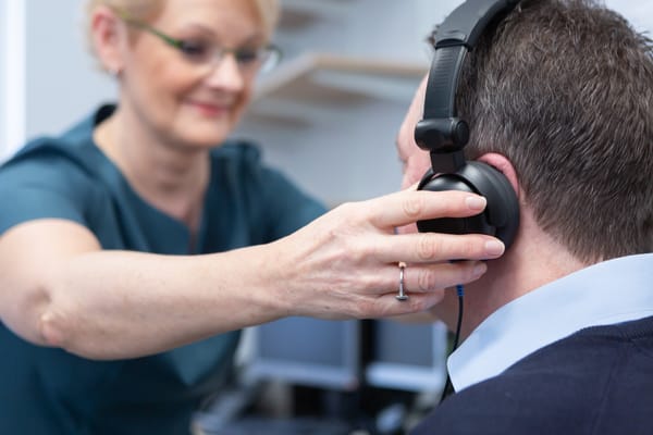 Karen Finch RHAD FSHAA FRSA, Owner and Lead Audiologist for All About Hearing, conducting a hearing assessment