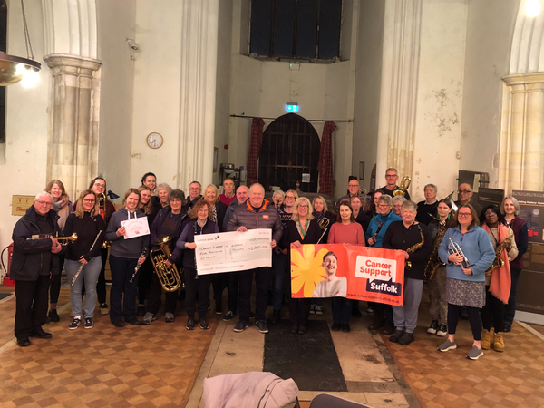 Ipswich Hospital Band, St Peter's Band, and Saints Community Band presenting the cheque to Mark Murphy of Cancer Support Suffolk