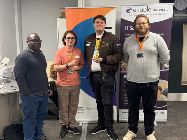 Winners of the hackathon, William King and Travis Brown, with Felix Ngobigha (University of Suffolk) and organiser Lewis Huxtable (IJYI)