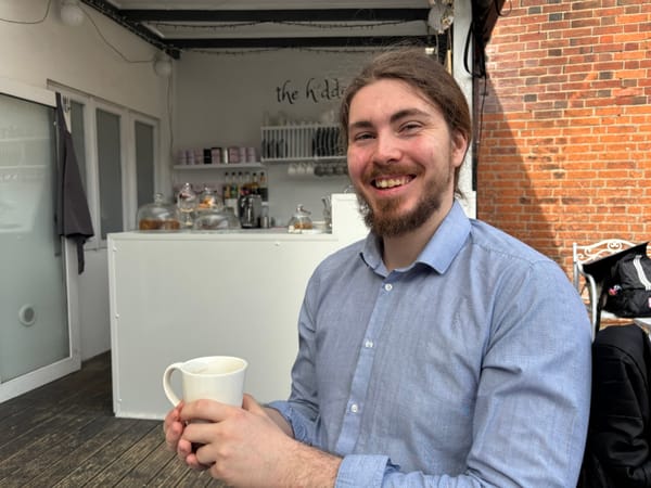 Adam Littler sitting in a cafe
