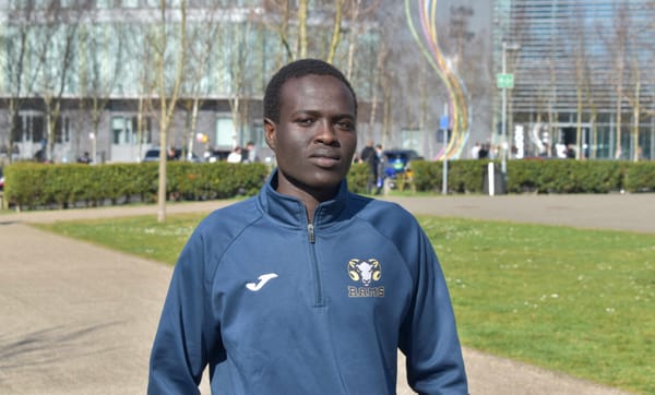 Osman in his training kit outside the college