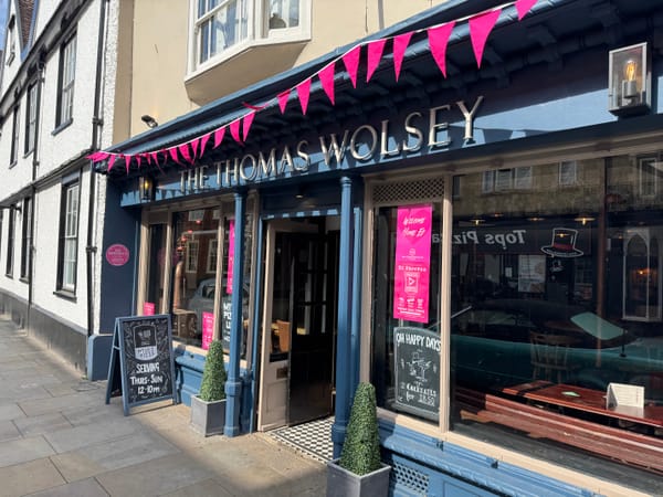 The Thomas Wolsey donning pink bunting, posters and plaque