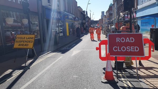 Road closure signs and workmen
