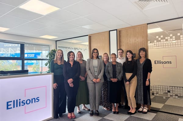 Group of people stood in office room