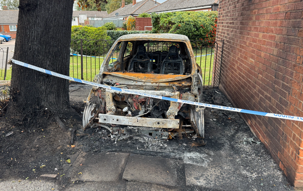 A burnt out car at the junction of Landseer Road and Clapgate Lane