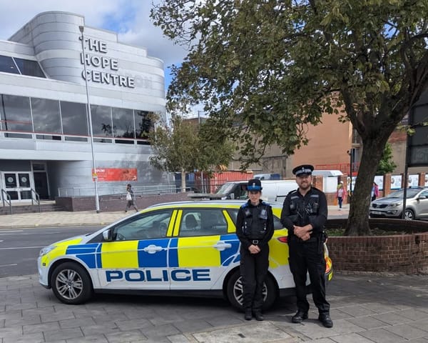 Two police officers outside the Hope Centre in Ipswich