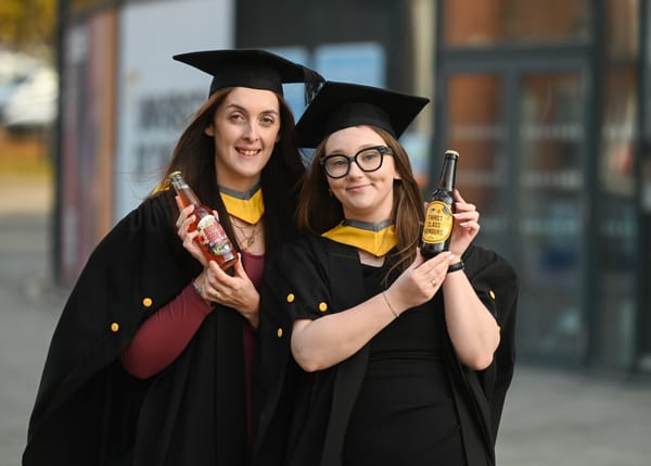 Adele Harris and Rebecca Mines holding their drinks